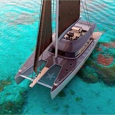 a sailboat floating in the ocean with blue water and corals on the bottom