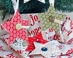 christmas tree ornaments are stacked on top of each other and decorated with red, white and green fabric