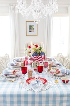 the table is set with red, white and blue place settings for an american celebration