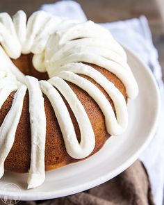 a bundt cake with white icing on a plate