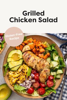 grilled chicken salad on a plate with avocado, tomatoes, and other vegetables