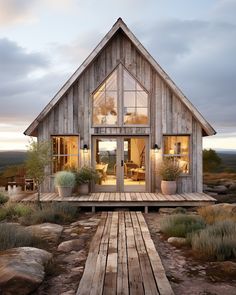 a small wooden house sitting on top of a lush green field