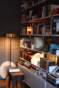 a living room filled with furniture and bookshelves covered in lots of different types of books