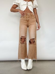 You'll be a trendsetter in Lane 201's Brown Crop Flare Denim! This piece features distressing at them hem and knees, a flare leg fit, pocket details, and a button and zipper closure. Pair with a cute white top and your favorite booties for the perfect transitional look! High Rise Distressing On Knees And Hem Flare Fit 100% Cotton Hand Wash Cold Distressed Cutoff Flare Jeans For Fall, Chic Distressed Mid-rise Flare Jeans, Chic Mid-rise Distressed Flare Jeans, Trendy Fall Flare Jeans With Frayed Hem, High Waist Ripped Cropped Jeans For Fall, Mid-rise Ripped Flare Jeans For Fall, Ripped Mid-rise Flare Jeans For Fall, Fall Distressed Straight Leg Flare Jeans, Fall High Rise Ripped Flare Jeans