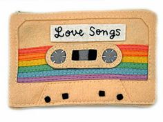 a small wallet with an old school cassette design on it that says love songs written on the front