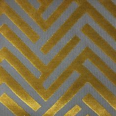 a gold and grey fabric with an interesting design on it's side, that is very similar to the pattern in this photo