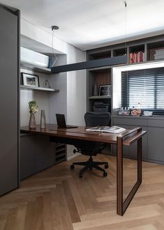 an office with a desk, chair and bookshelf in the corner is shown