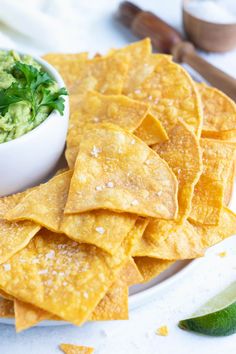 some tortilla chips and guacamole on a plate