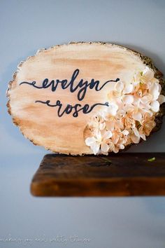 a piece of wood with flowers on it and the words evelyn rose written in black ink