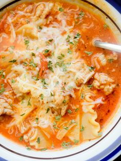 a bowl of pasta soup with meat and cheese on the top is ready to be eaten