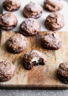 chocolate cookies on a cutting board with powdered sugar