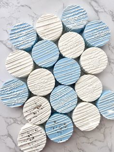 blue and white striped cookies are arranged on a marble counter top with chocolate chips in the shape of circles