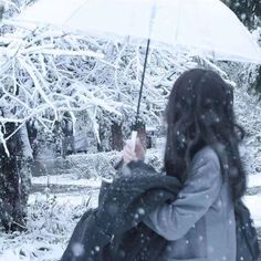 a woman holding an umbrella in the snow