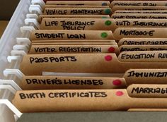 several file folders with labels on them are lined up in a row and labeled birth certificates