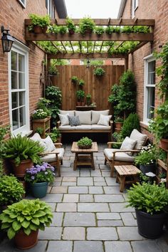 an outdoor living area with couches and potted plants