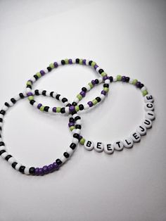 BEETLEJUICE BEETLEJUICE BEETLEJUICE! Beetlejuice Bracelet Stack of 3 bracelets. Spooky Szn Beetlejuice Beaded Bracelet, Beetle Juice Bracelets, Beetlejuice Jewelry Diy, Spooky Bracelet Ideas, Beetlejuice Bracelet Ideas, Ideas For Bracelets With Beads, Beetlejuice Bracelet, Beetlejuice Jewelry, Silly Bracelets