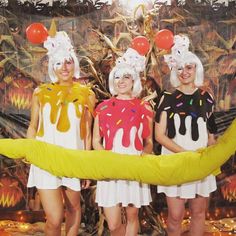 three women in costumes standing next to a banana