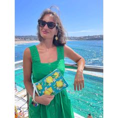 Arancia Piana Clutch Bag The limelight's yours with the striking 'Amalfi Limonata' clutch, featuring hand-painted lemons on a teal, ocean-blue canvas. Gorgeous as a purse, or an organizer pouch for jewelry, make-up & other bits and pieces for easy switching from bag to bag. Planning an Italian themed wedding? The clutch makes the perfect gift for bridesmaids, weddings, Italy lovers or yourself. And for a touch that’s as sweet as the sights of Italia. Fashioned from animal friendly, sustainable v Italian Themed Wedding, Weddings Italy, Amalfi Coast Travel, Lemon Design, Custom Denim, Personalized Teacher Gifts, Leather Clutch Bags, Bridesmaid Flowers, Blue Canvas