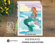 the mermaid stained glass pattern is next to some flowers