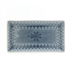 a blue and white plate with an intricate design on the edge, against a white background