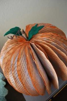 an orange paper pumpkin sitting on top of a table