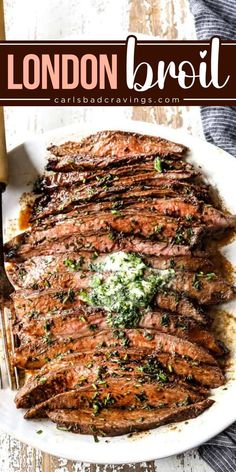 the london broil steak is served on a white plate with a fork and knife