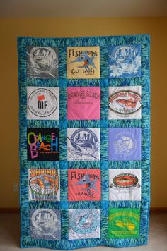 a quilted wall hanging with various t - shirts on it