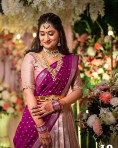 a woman in a purple and gold sari