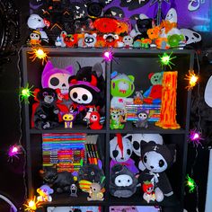 a book shelf filled with lots of stuffed animals and halloween decorations on top of it