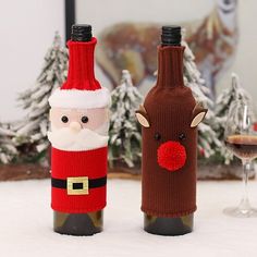 two wine bottles decorated like santa claus and reindeer