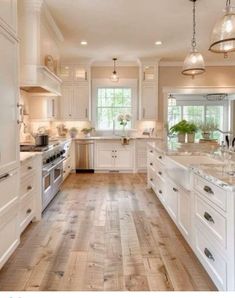 a large kitchen with white cabinets and wood floors is featured in this post - it - yourself photo