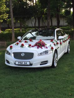 a white car with flowers on the hood