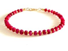 Natural Luxe AAA true red faceted 3.5-4.5mm ruby gemstone bracelet beaded with Karen Hill Tribe 24k gold vermeil spacers and 14k gold fill clasp. Also available in sterling silver with Karen Hill Tribe fine silver accents. When selecting size please add 1/2 to 3/4 inches for a comfortable fit. Cheap Red Beaded Bracelets With Gold Beads, Ruby Bracelet, Jewelry Chest, Ruby Beads, Hill Tribe Silver, Star Ruby, Bracelet Beaded, True Red, July Birthstone