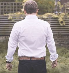 a man in white shirt and black pants holding hands