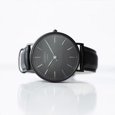 Discover the epitome of refined elegance with the Men's Minimalist Watch featuring a Pitch Black Mesh Strap. This timepiece embodies the philosophy that sometimes, less truly is more. Crafted with an unwavering attention to detail, this watch is designed for those who appreciate both simplicity and sophistication. The watch showcases a high-quality stainless steel case that houses a precise quartz mechanism, ensuring reliable timekeeping. The handcrafted quick-release stainless steel mesh strap adds a touch of modernity while providing comfort and style. Its sleek, minimalist design is elevated by the opportunity to personalize the back of the watch with an engraved message in a modern font, making it a unique and meaningful gift. Water-resistant up to 3ATM, this watch is as practical as i Engraved Handwriting, Minimalist Men, Personalized Watches, Watch Engraving, Minimalist Watch, Stainless Steel Polish, Watch Companies, Modern Fonts, Less Is More