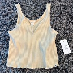 Light Yellow Billabong Tank Top. Tags Still On. Size Medium. Very Good Condition And Cute. If Interested At All Please Offer! On Any Of My Clothes! Trying To Get Rid Of!! Casual Cropped Beige Tank Top, Casual Beige Cropped Tank Top, Casual Ribbed Tops For Vacation, Ribbed V-neck Top For Beach, Ribbed V-neck Beach Top, My Clothes, Bedroom Lighting, Light Yellow, Billabong