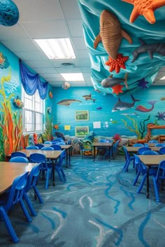 an ocean themed classroom with under the sea theme on the walls and tables in front of them