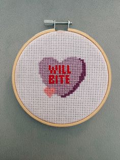 a cross - stitch heart with the words bill bite written on it in red and pink