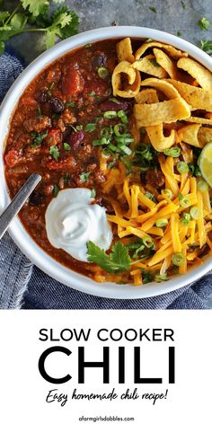 slow cooker chili recipe in a bowl with sour cream and tortilla chips