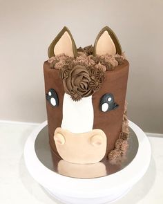 a cake decorated with a cow head and flowers