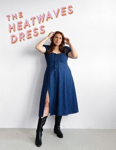 a woman standing in front of a wall with the words heatwaves dress on it