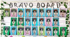 an art display with many different colored faces on the front and back of each board