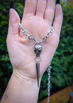 Gothic skull and long spike chain necklace 💀 This necklace is made of 100% stainless steel so is completely waterproof and won't tarnish or discolour! Available in various sizes: Small (shown in photographs) Measures 16 inches and comes with a 2.5 inch extension chain  Medium  Measures 18 inches and comes with a 2.5 inch extension chain  Large  Measures 20 inches and comes with a 2.5 inch extension chain  Please don't hesitate to contact me with any queries or suggestions 😊 Comes gift wrapped Gothic Skull, Pendant Necklaces, Halloween Shopping, Favorite Jewelry, Necklace Etsy, Jewelry Necklace Pendant, Chain Necklace, Accessory Gift, Jewelry Necklaces