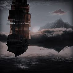 a ship floating on top of the ocean under a cloudy sky