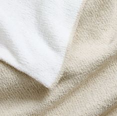 the texture of a blanket is white and beige