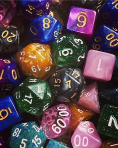 many different colored dice with numbers on them