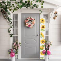 the front door is decorated with flowers and wreaths