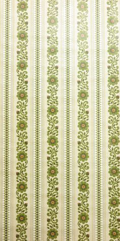 a green and white striped wallpaper with small flowers on the side, in an ornate pattern