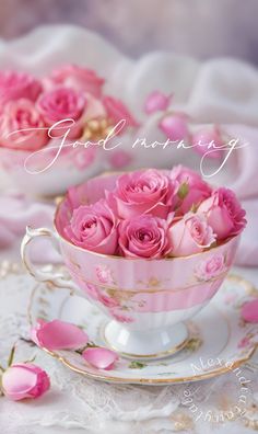 pink roses are in a teacup with the words good morning written on it,