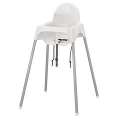 a white high chair sitting on top of a table